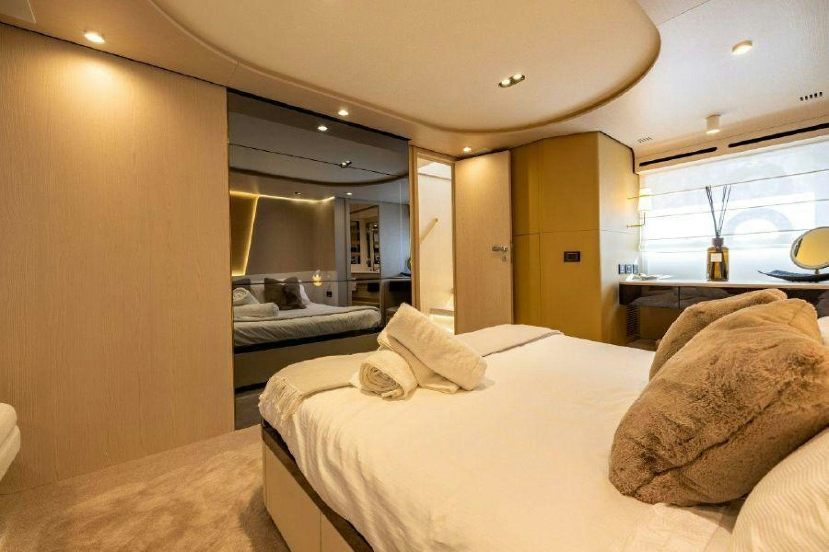 a room with a bed and a mirror aboard SUN LIFE Yacht for Sale