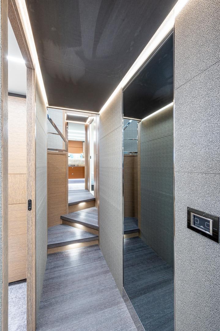 a hallway with a door and a railing aboard LEBRADA Yacht for Sale