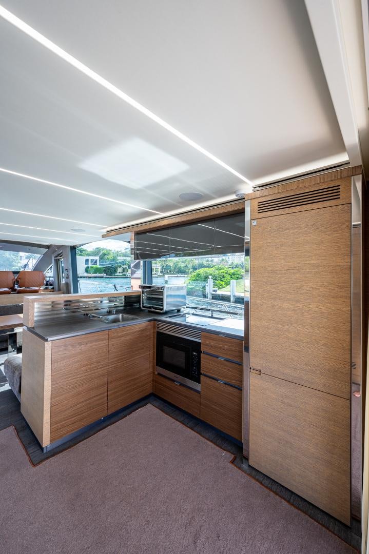 a kitchen with a large window aboard LEBRADA Yacht for Sale