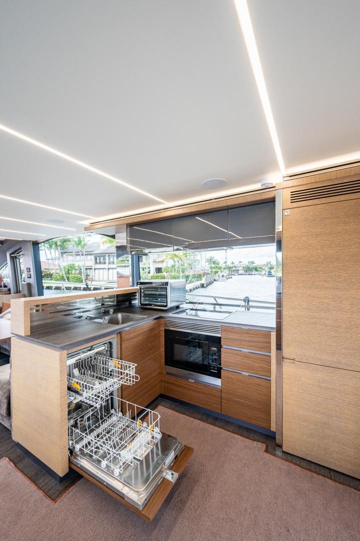 a kitchen with a large window aboard LEBRADA Yacht for Sale
