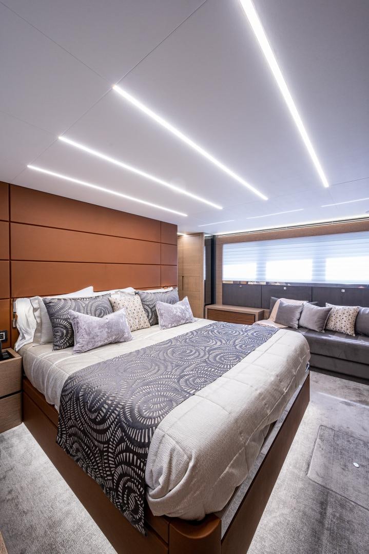a bed with a white bed aboard LEBRADA Yacht for Sale