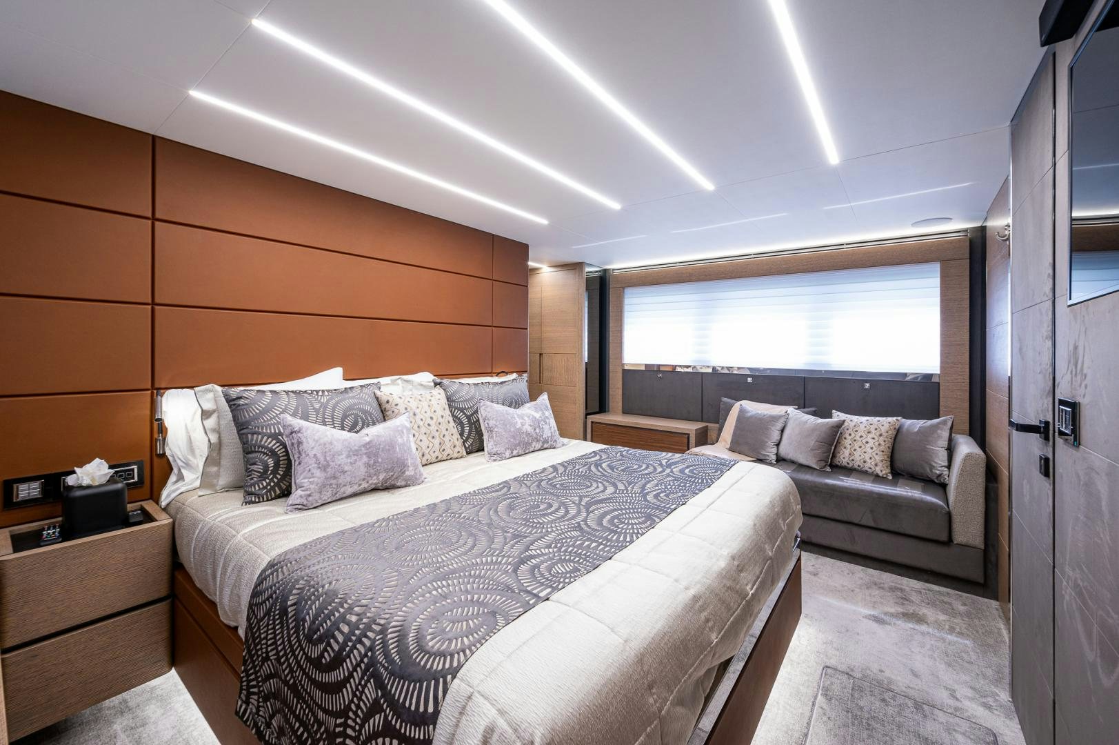 a bedroom with a bed and a couch aboard LEBRADA Yacht for Sale
