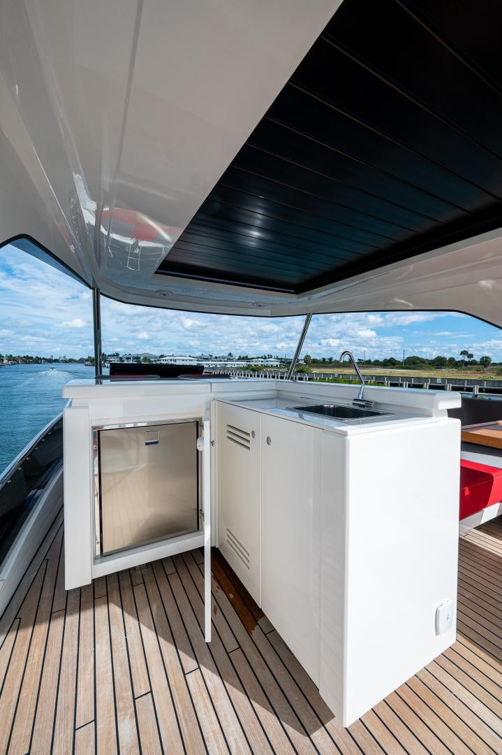 a deck with a large white stove and a large window aboard LEBRADA Yacht for Sale