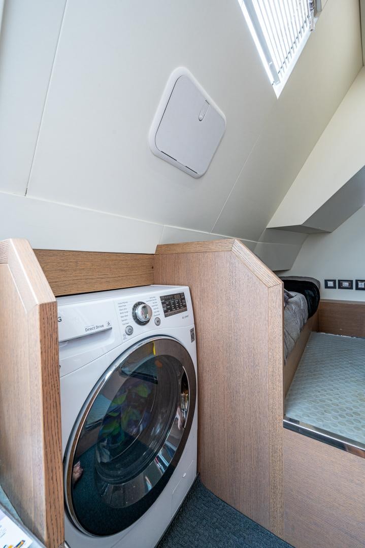 a washing machine in a room aboard LEBRADA Yacht for Sale