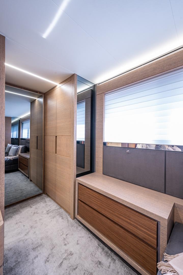 a room with a wood floor and a window with a wood railing aboard LEBRADA Yacht for Sale