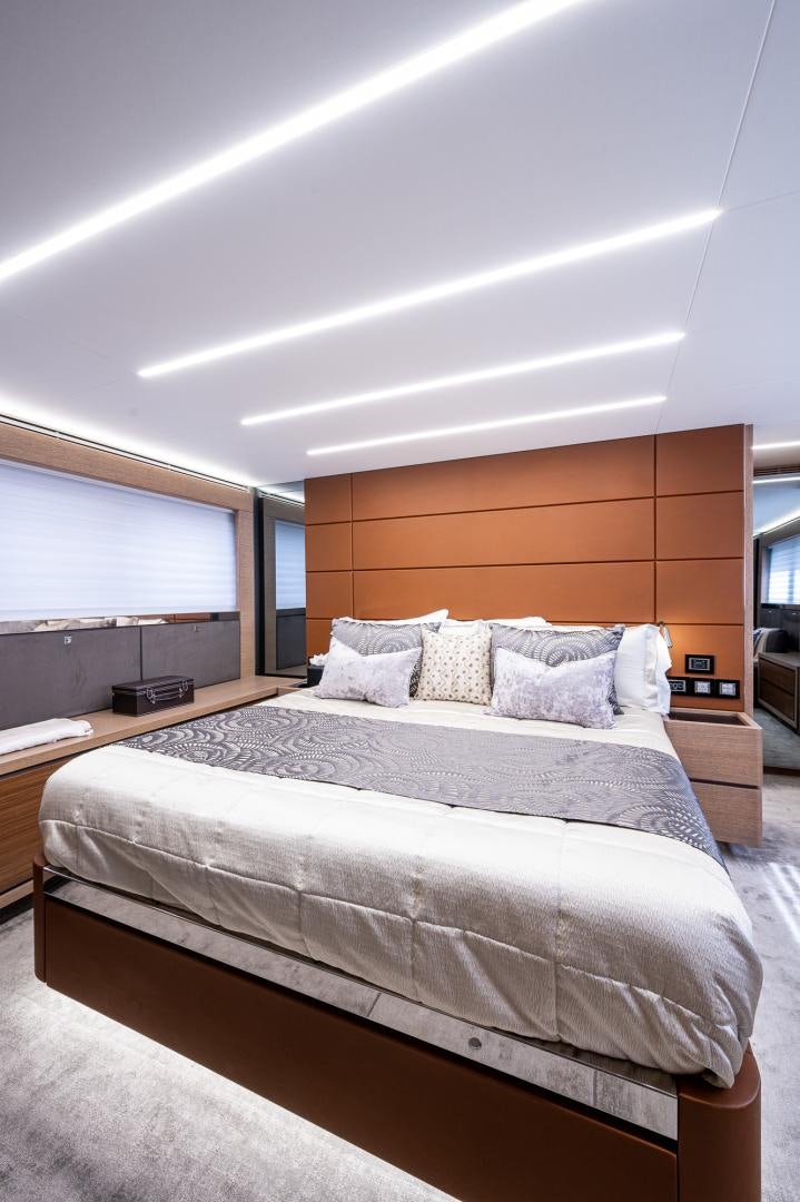 a bed with a white comforter aboard LEBRADA Yacht for Sale