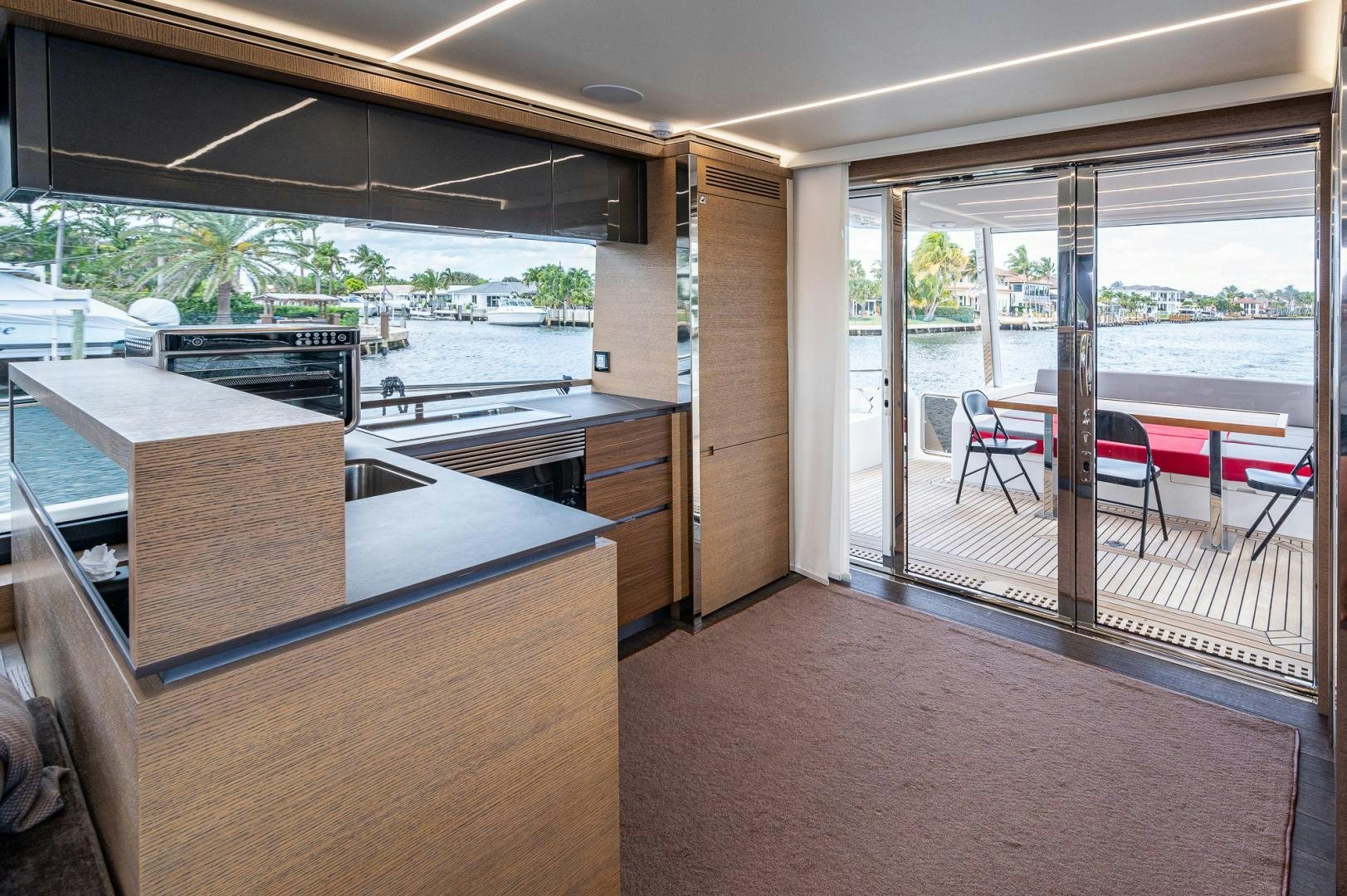 a room with a large window and a table and chairs aboard LEBRADA Yacht for Sale