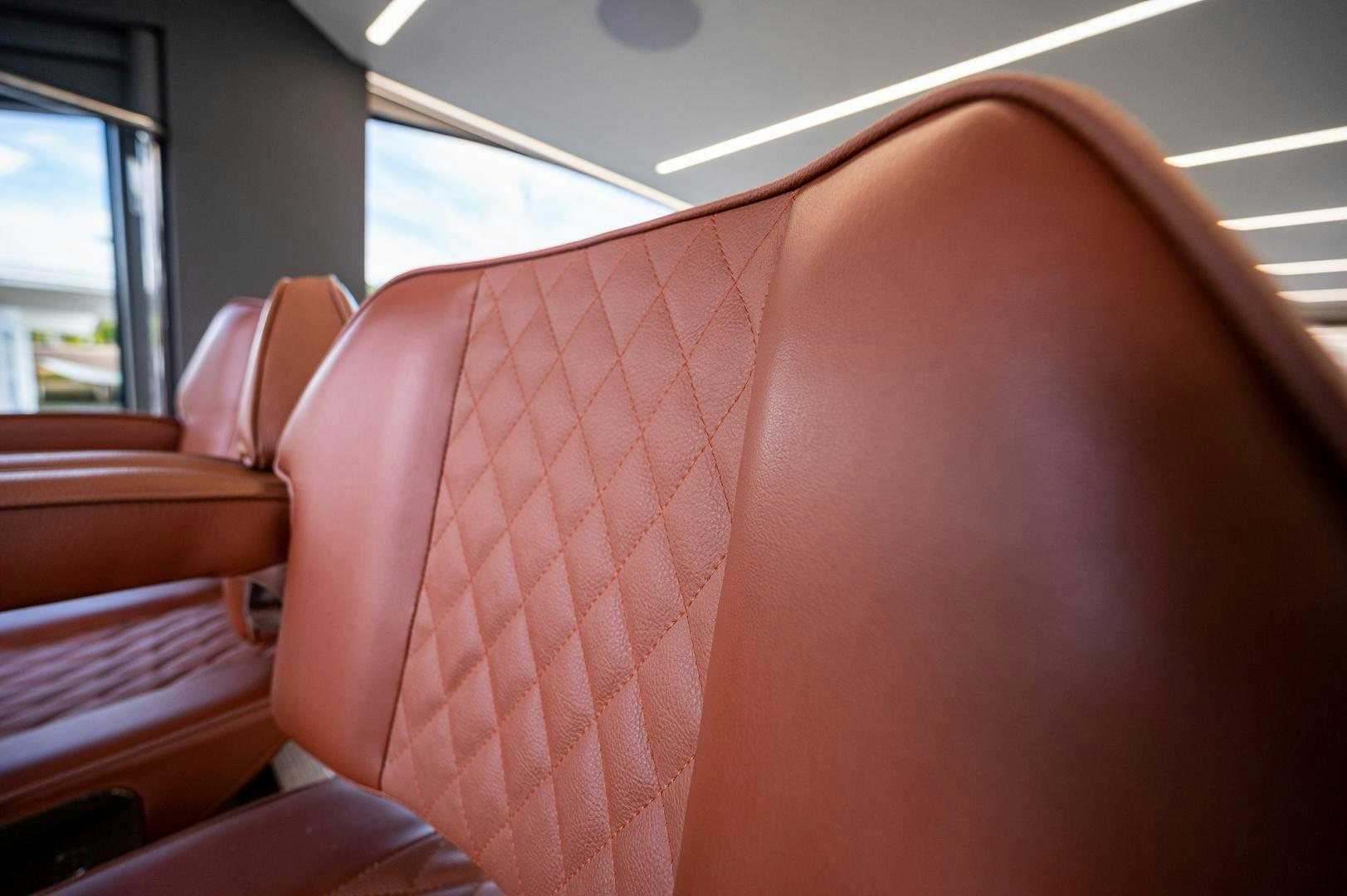 a row of red seats aboard LEBRADA Yacht for Sale