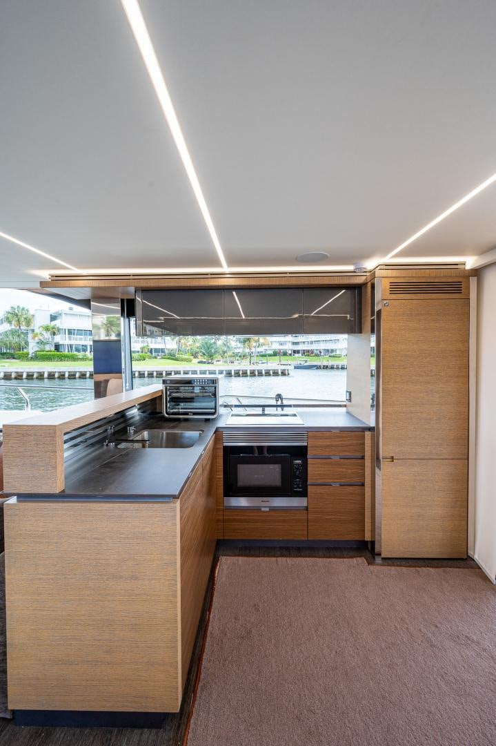 a kitchen with a large window aboard LEBRADA Yacht for Sale