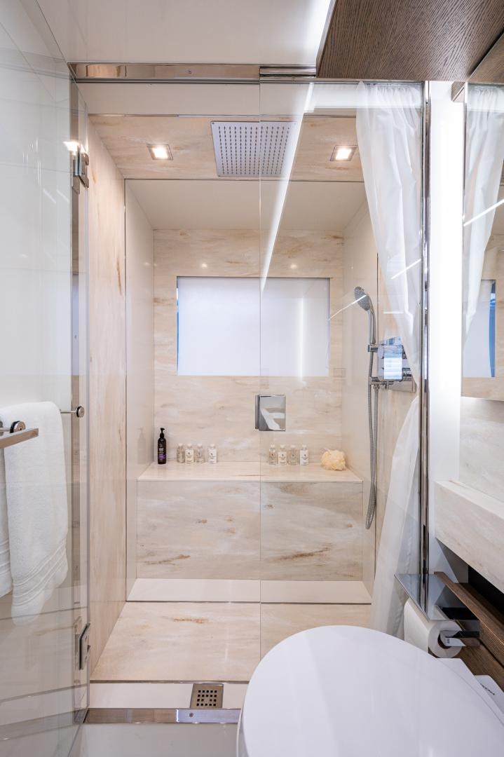 a bathroom with a shower and toilet aboard LEBRADA Yacht for Sale