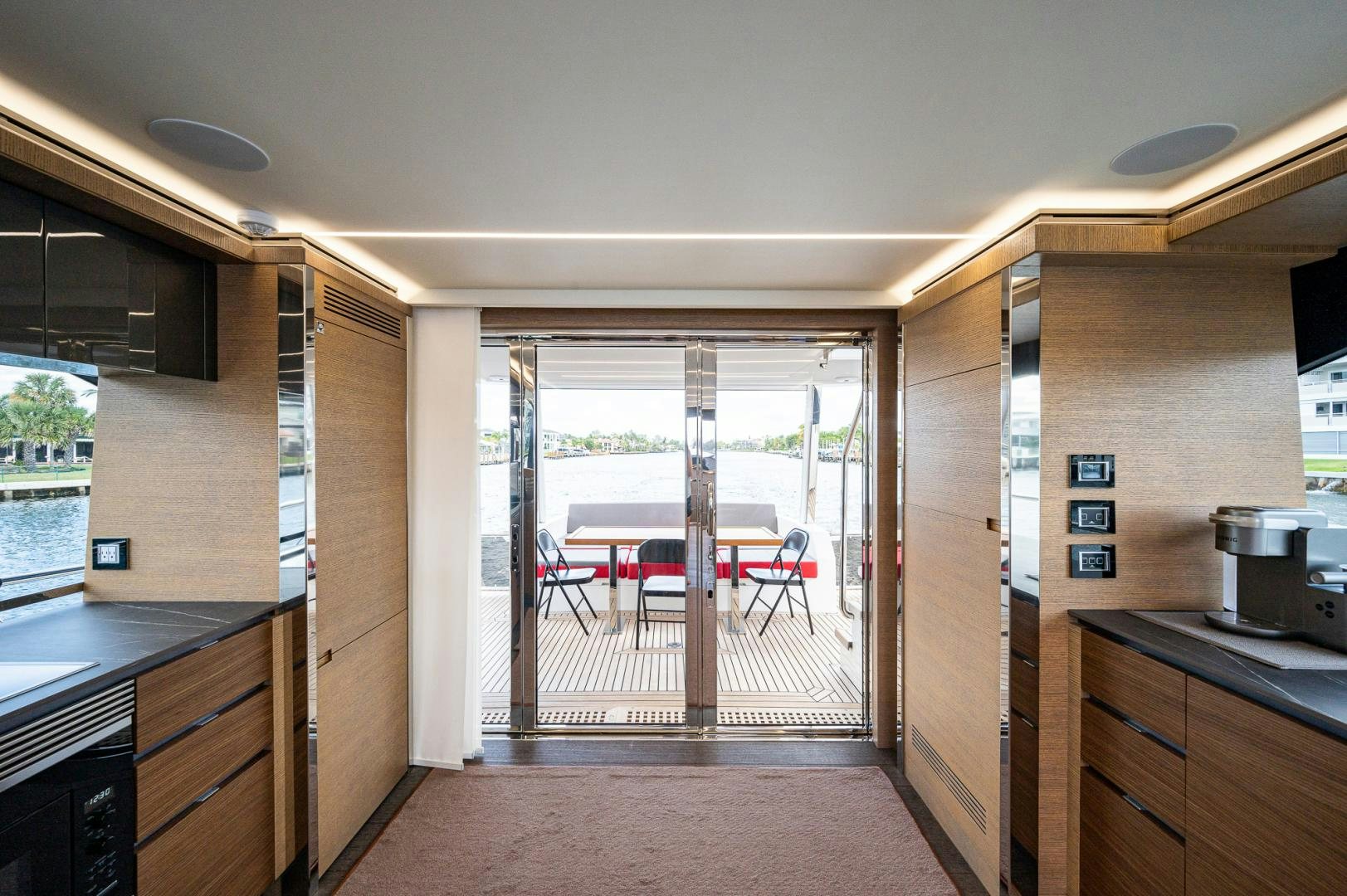 a kitchen with a sliding glass door aboard LEBRADA Yacht for Sale