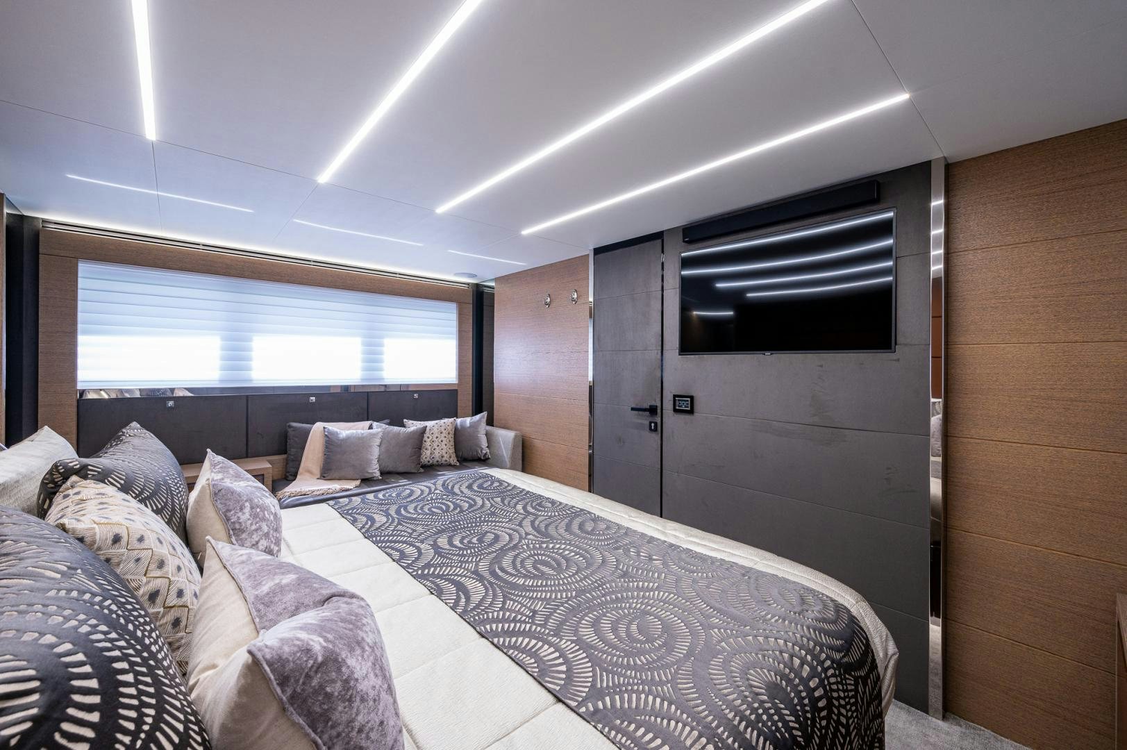 a bedroom with a bed and a large window aboard LEBRADA Yacht for Sale