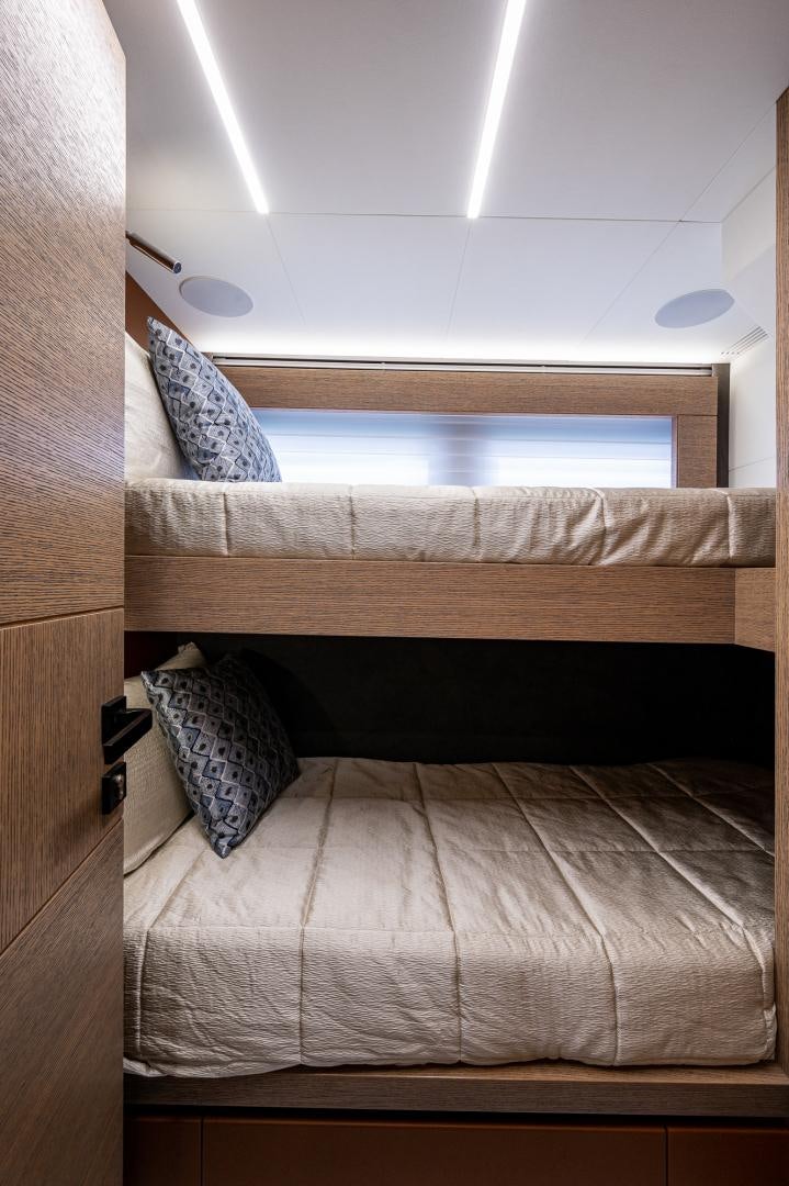 a bed with a wooden headboard aboard LEBRADA Yacht for Sale