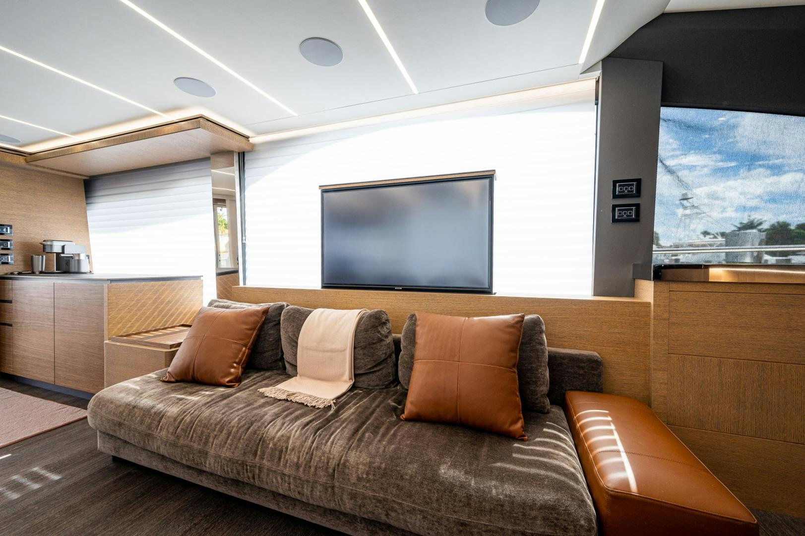 a living room with a large screen aboard LEBRADA Yacht for Sale