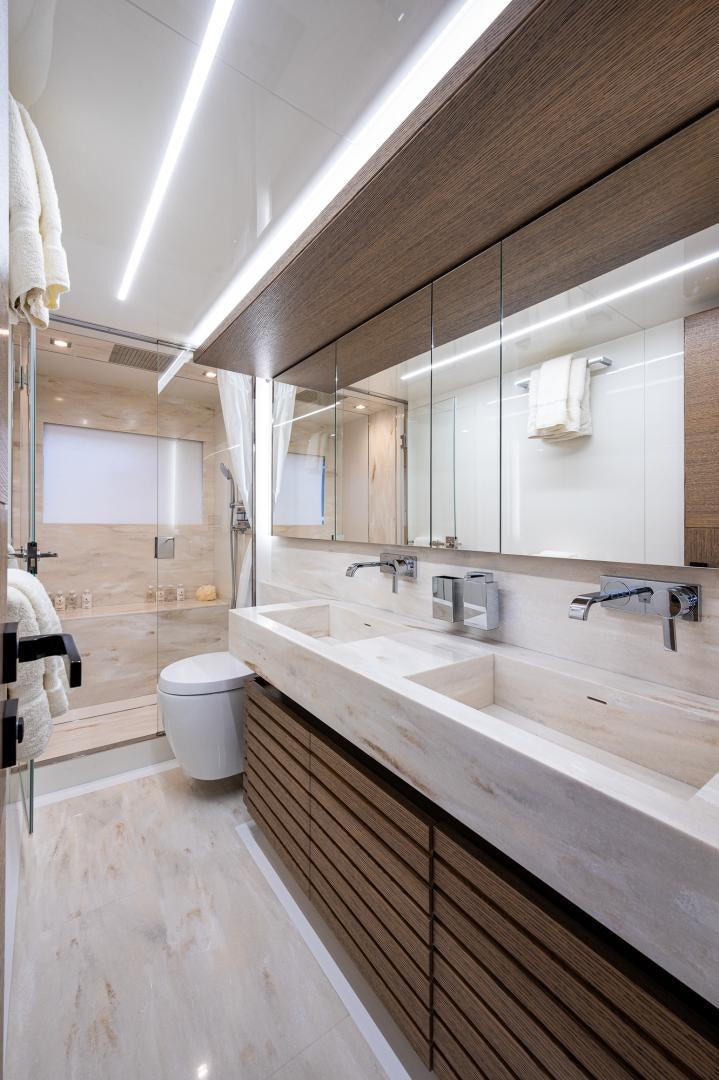 a bathroom with a tub sink and toilet aboard LEBRADA Yacht for Sale
