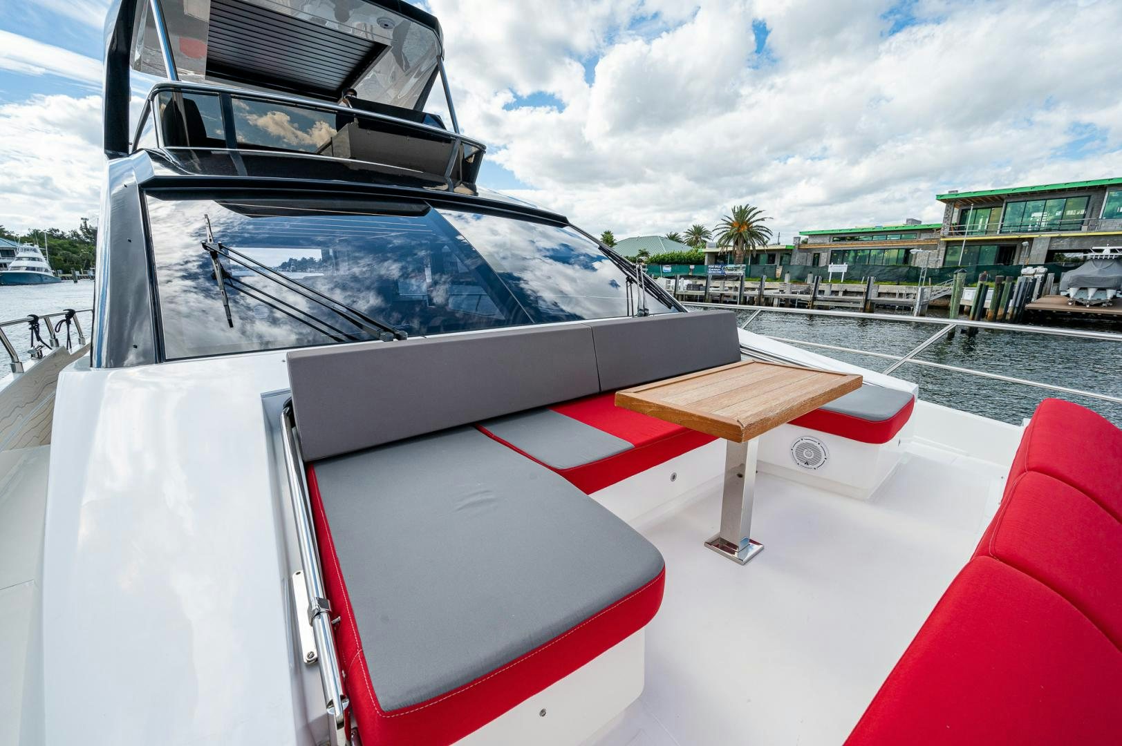 a white car with a table and a bench on a deck aboard LEBRADA Yacht for Sale