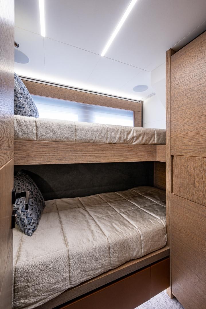 a bed with a wooden frame aboard LEBRADA Yacht for Sale
