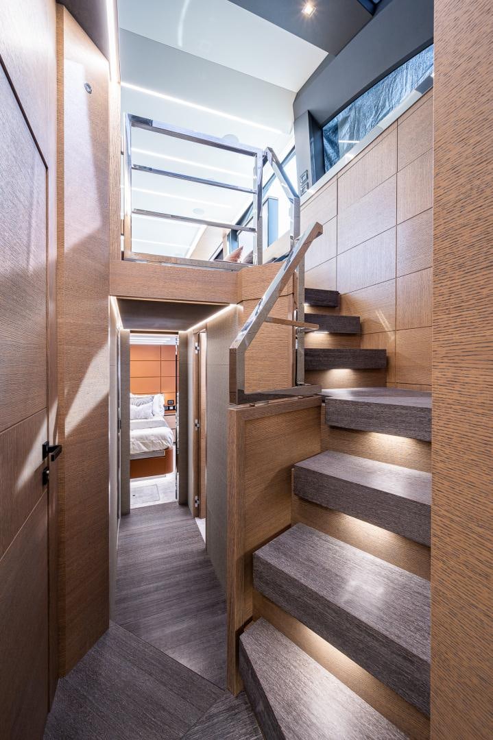 a wooden staircase in a room aboard LEBRADA Yacht for Sale