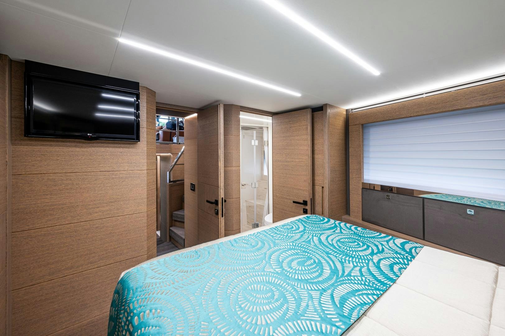 a large room with a television and a bed aboard LEBRADA Yacht for Sale
