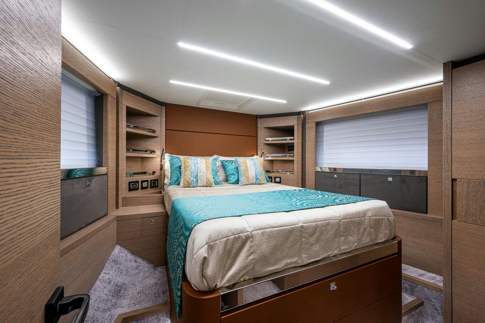 a bedroom with a bed and a window aboard LEBRADA Yacht for Sale