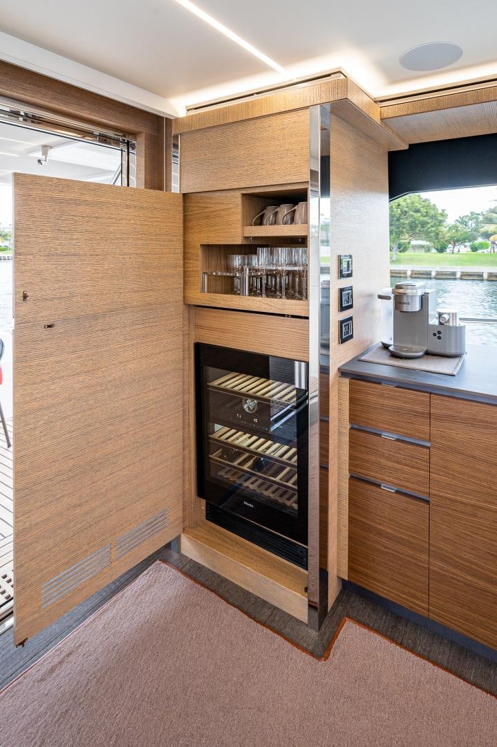 a kitchen with wooden cabinets aboard LEBRADA Yacht for Sale