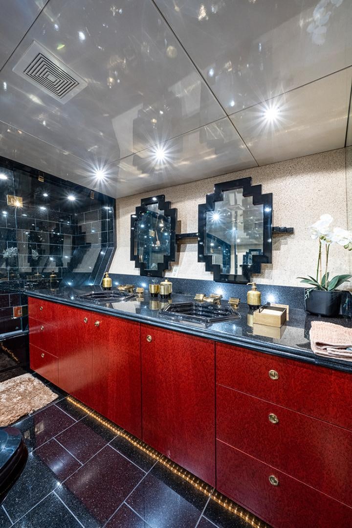 a kitchen with red cabinets aboard CANDY WORLD Yacht for Sale