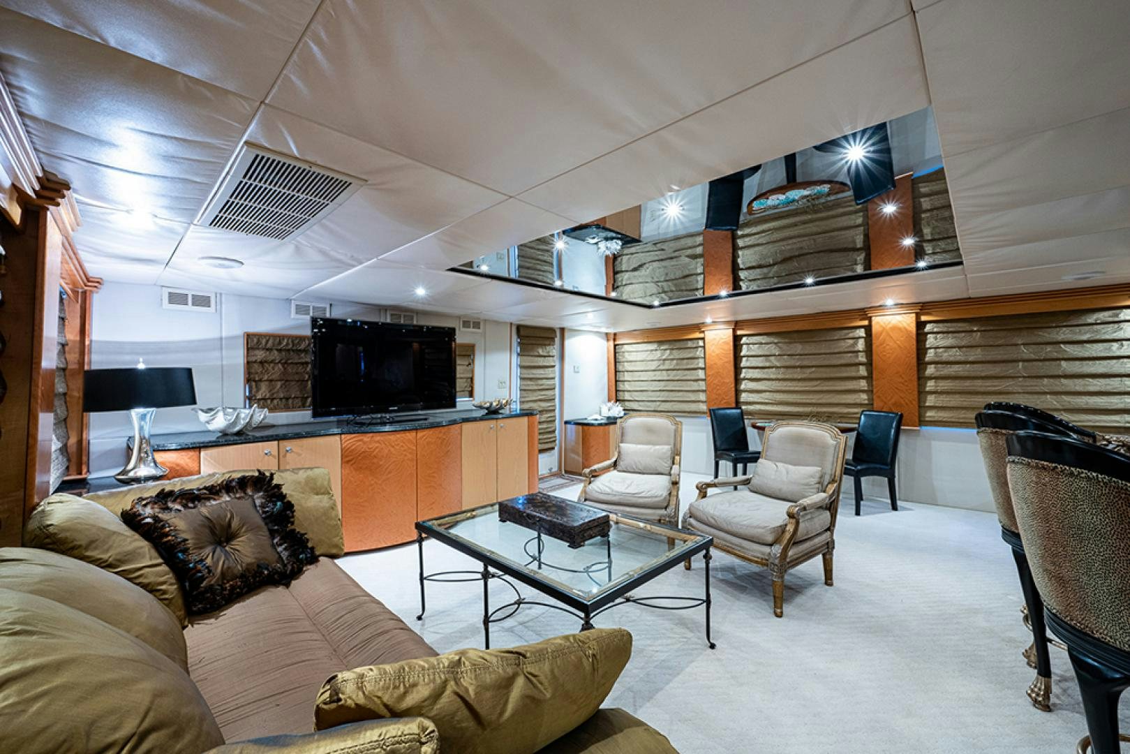 a living room with a table and chairs aboard CANDY WORLD Yacht for Sale