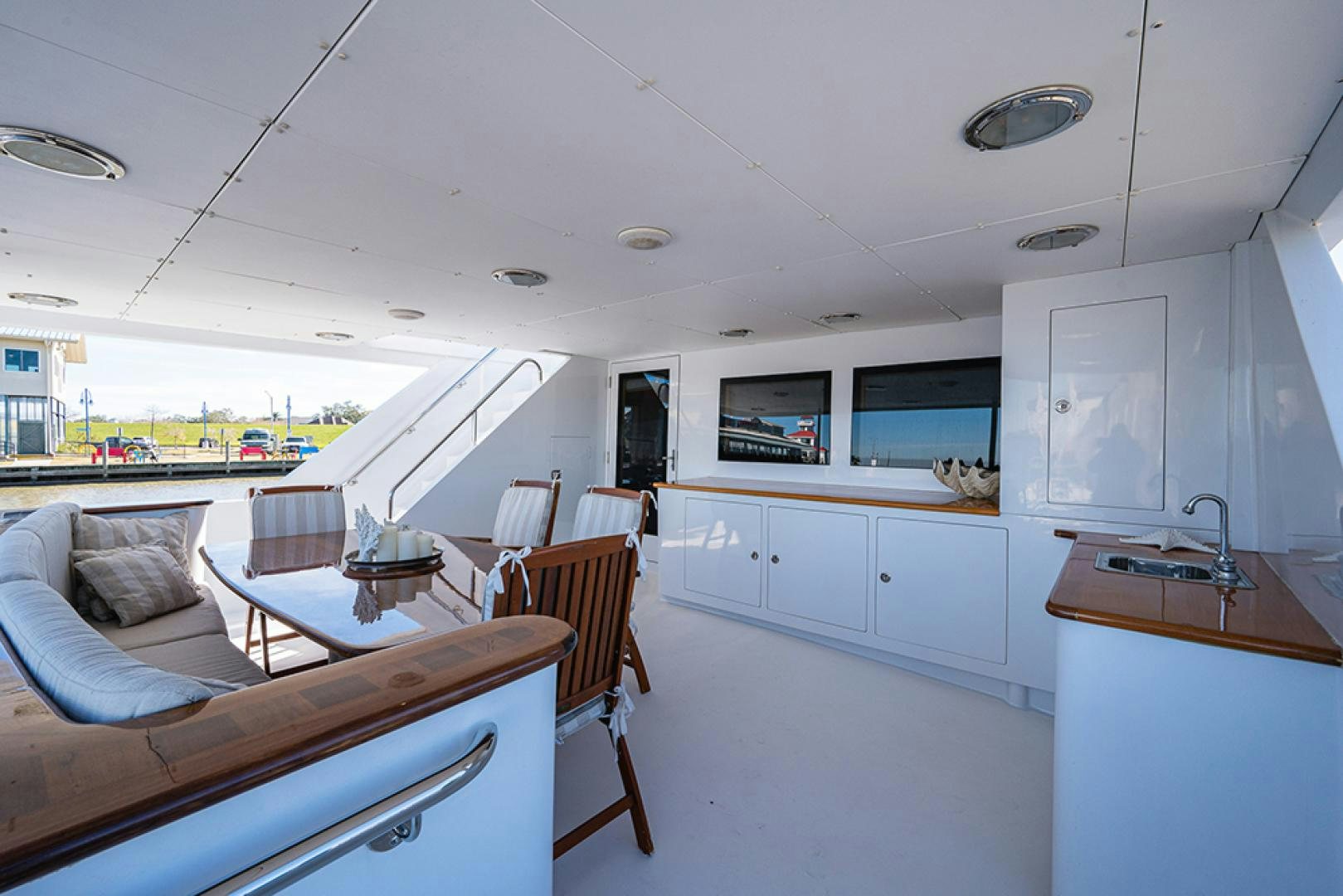 a large white kitchen with a large open area with a table and chairs aboard CANDY WORLD Yacht for Sale