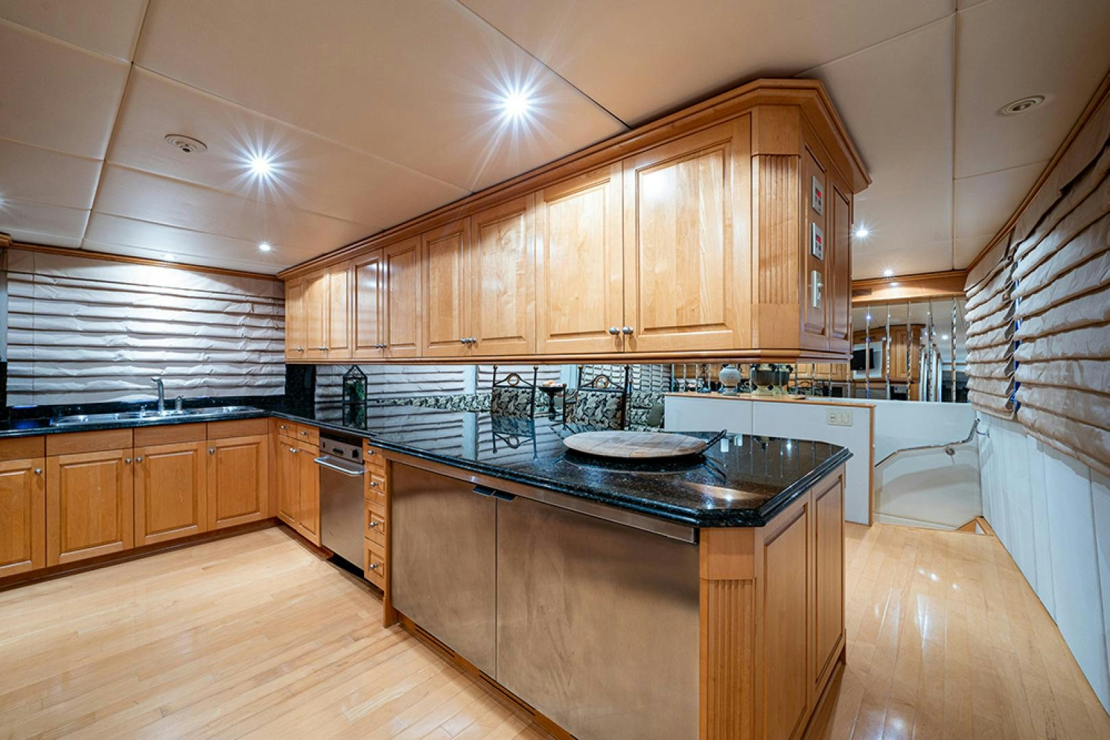a kitchen with wooden cabinets aboard CANDY WORLD Yacht for Sale