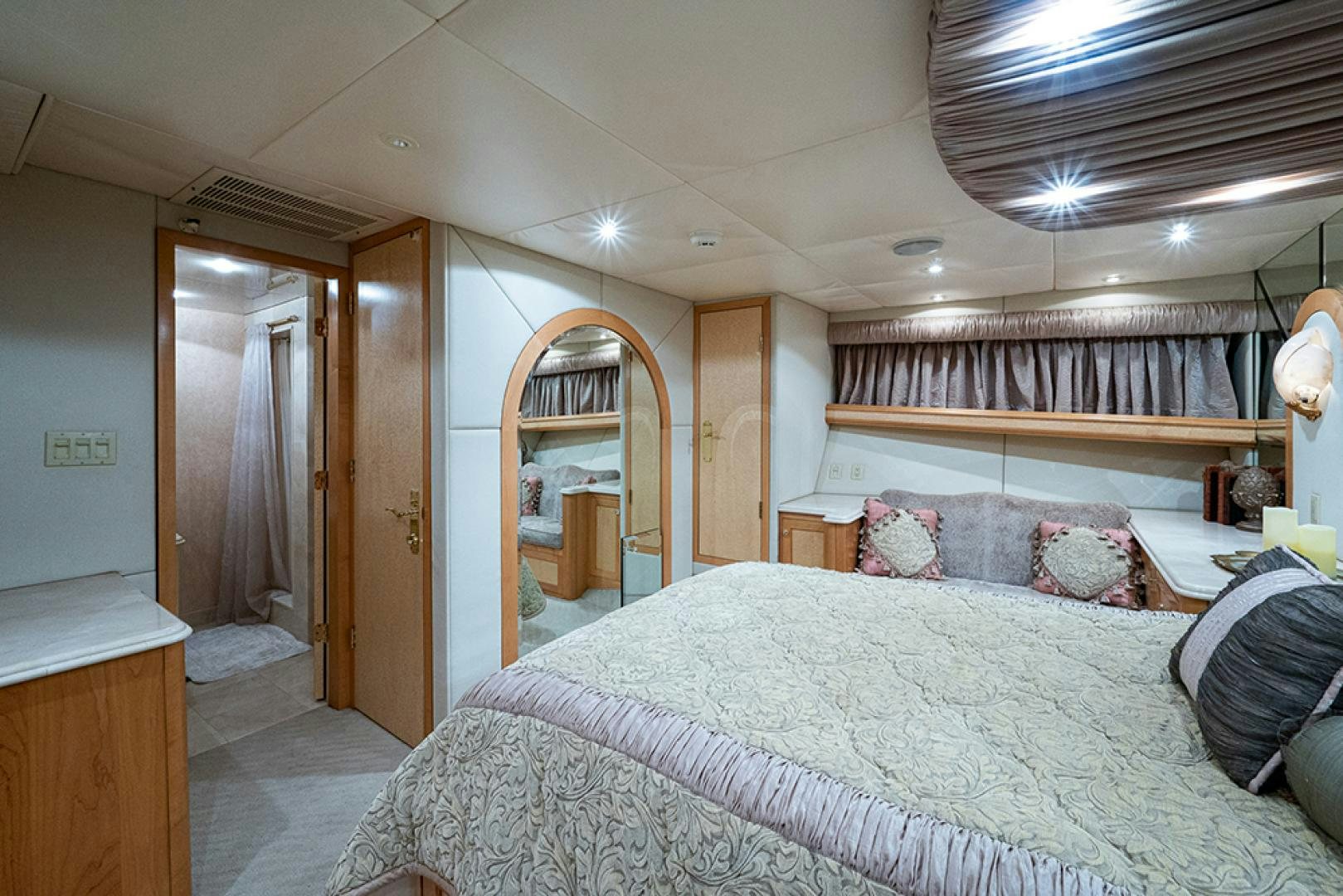 a bedroom with a bed and a mirror aboard CANDY WORLD Yacht for Sale