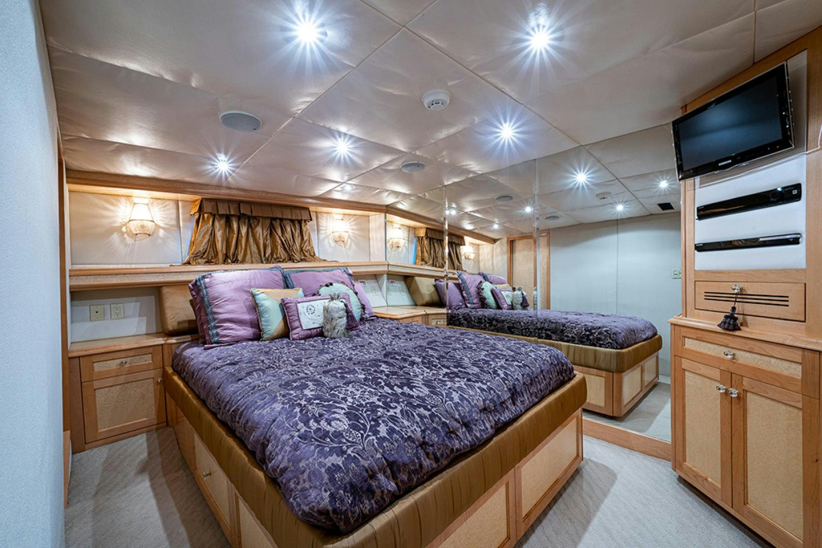 a bedroom with a bed and a tv aboard CANDY WORLD Yacht for Sale