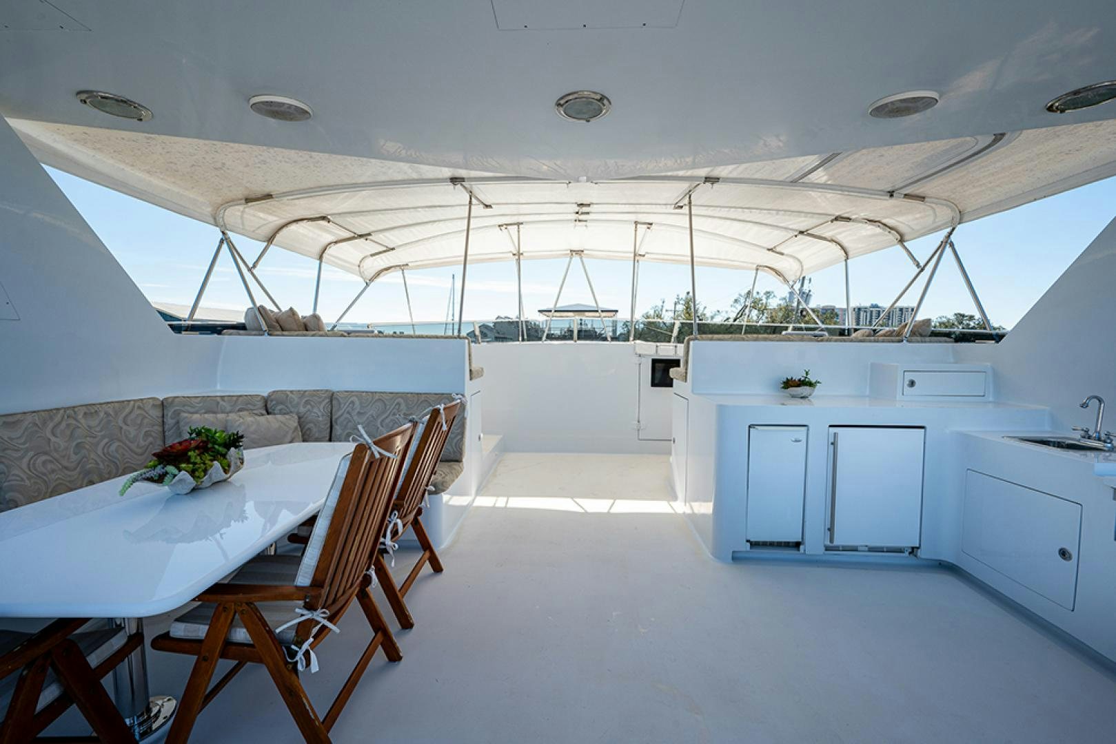a large white room with tables and chairs aboard CANDY WORLD Yacht for Sale