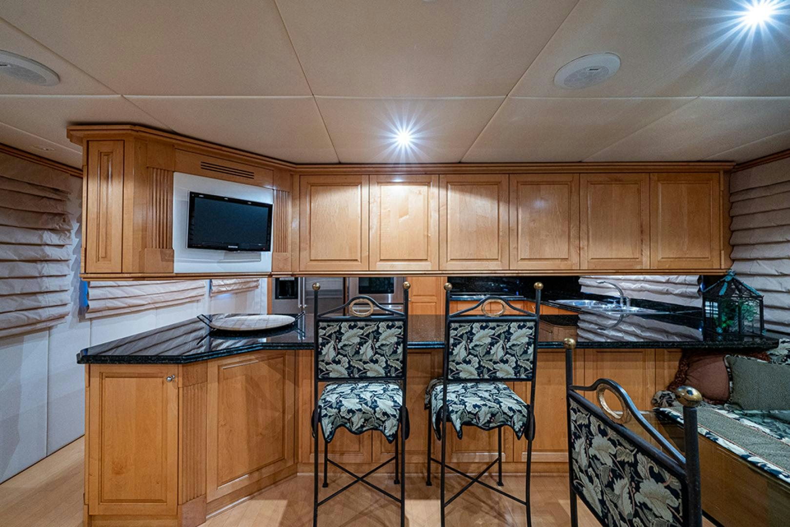 a kitchen with wooden cabinets aboard CANDY WORLD Yacht for Sale