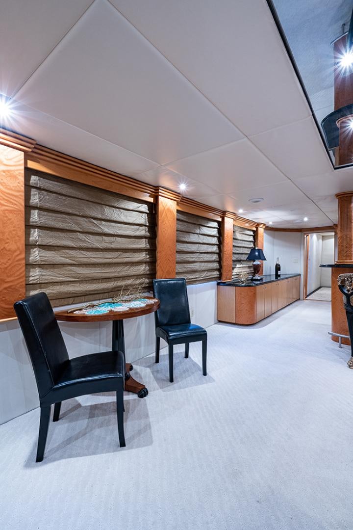 a room with a table and chairs aboard CANDY WORLD Yacht for Sale