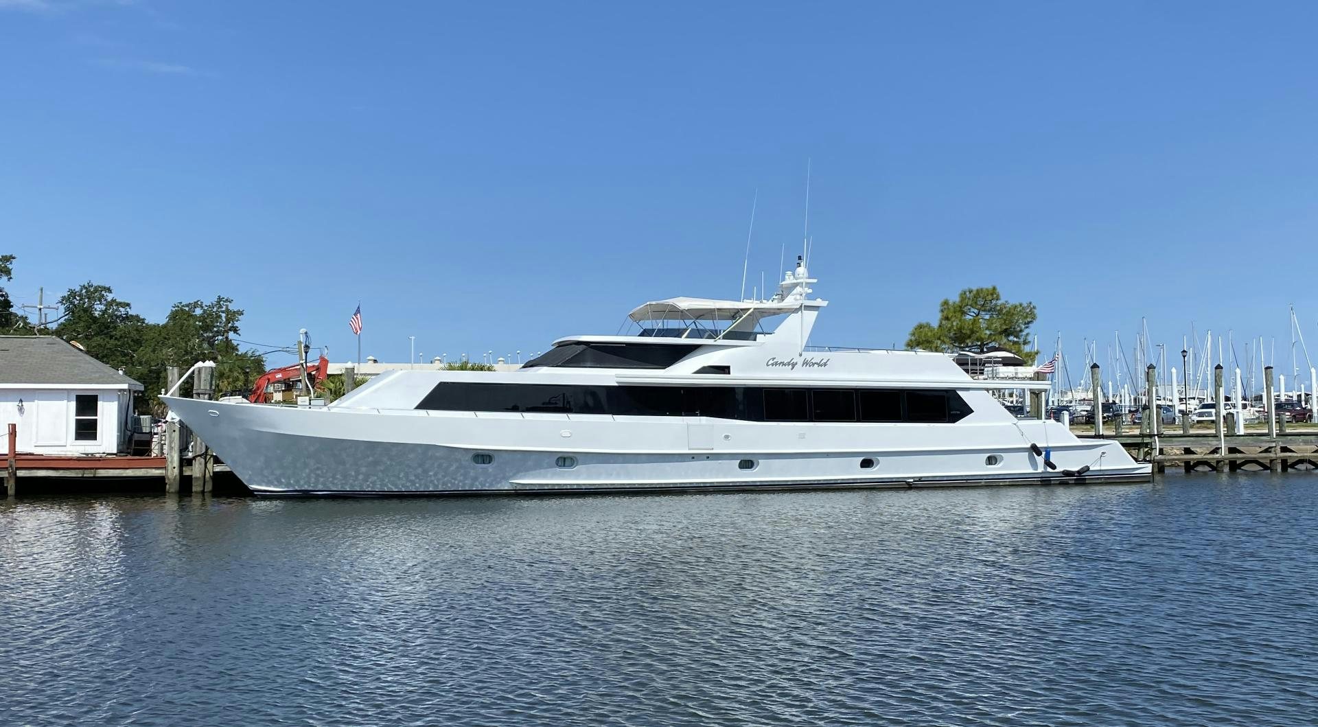 a white yacht in a harbor aboard CANDY WORLD Yacht for Sale