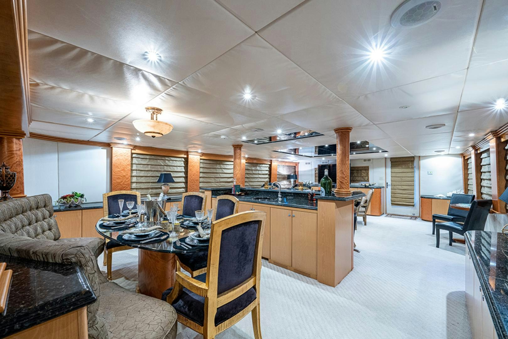 a large room with a table and chairs aboard CANDY WORLD Yacht for Sale