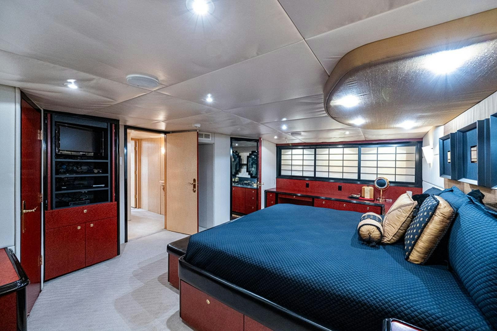a bedroom with a bed and a desk aboard CANDY WORLD Yacht for Sale