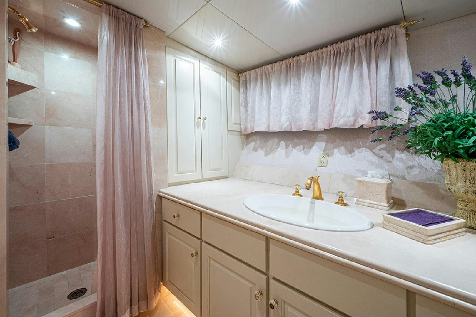 a bathroom with a sink and a shower curtain aboard CANDY WORLD Yacht for Sale
