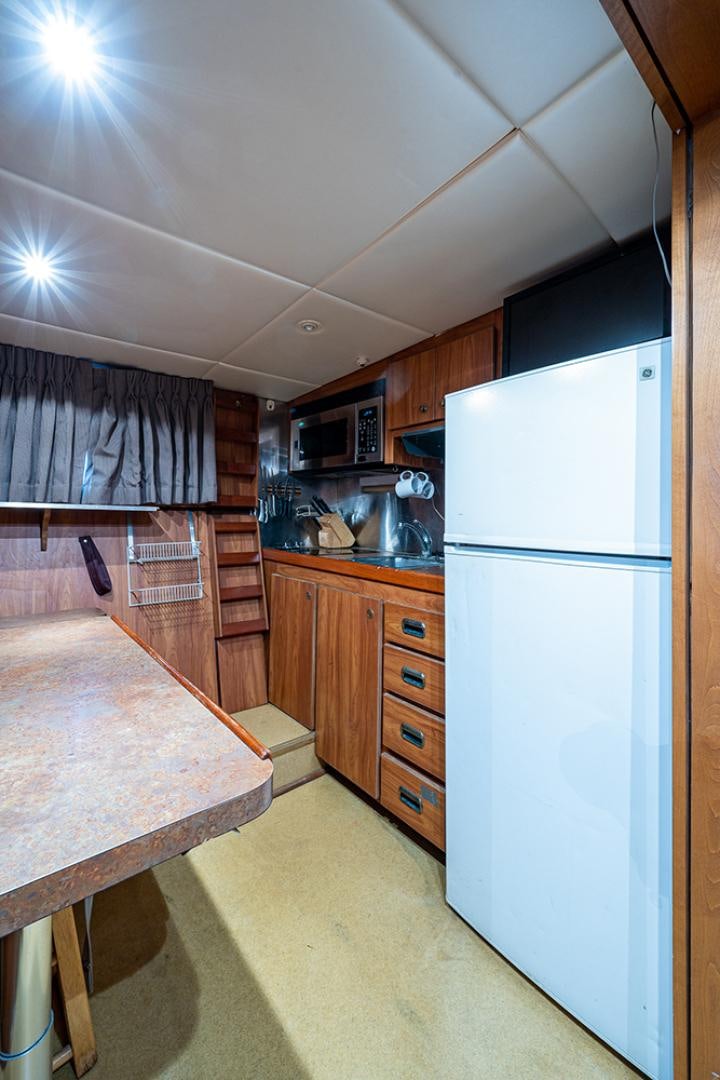a kitchen with a large island aboard CANDY WORLD Yacht for Sale
