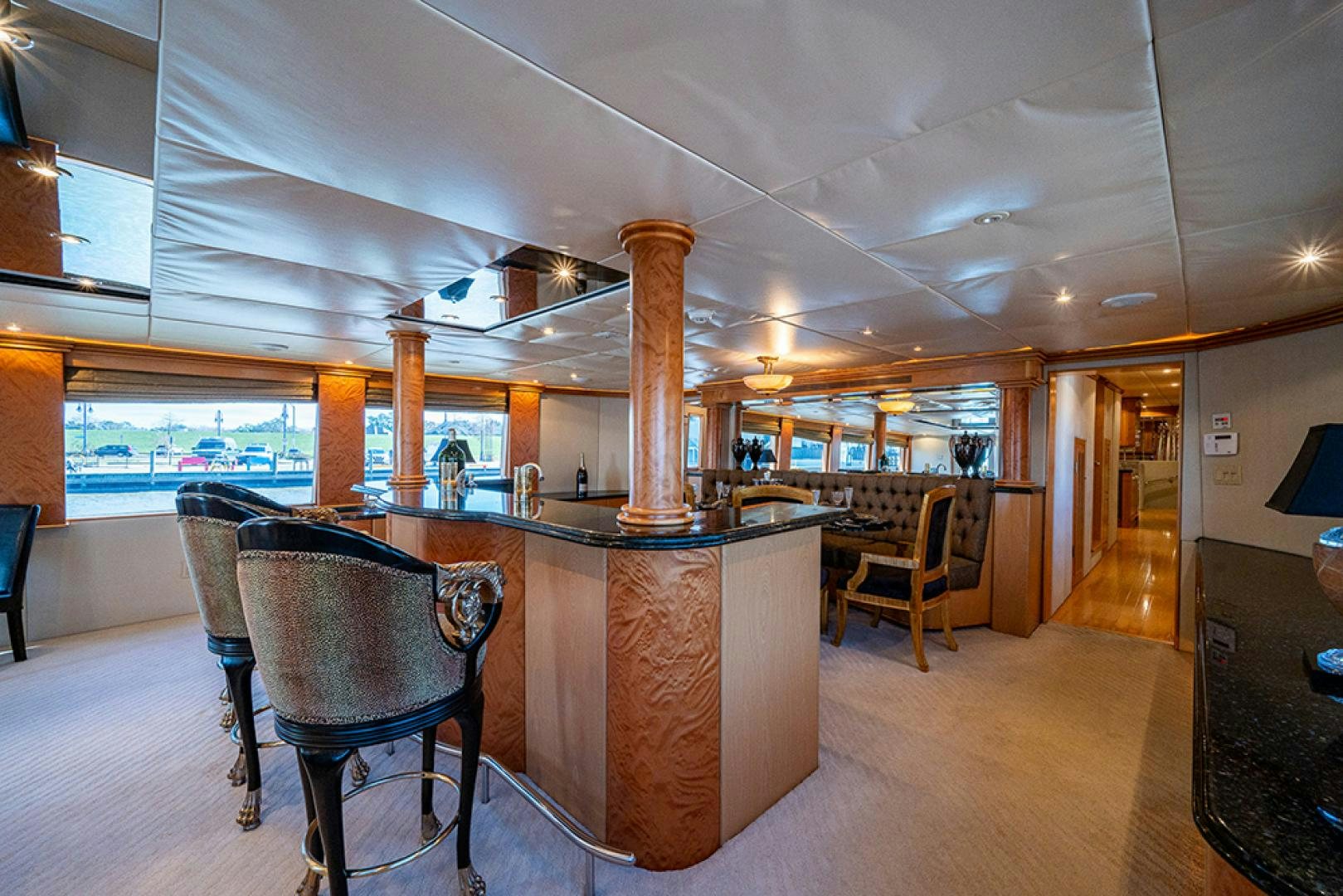 a bar with a table and chairs aboard CANDY WORLD Yacht for Sale