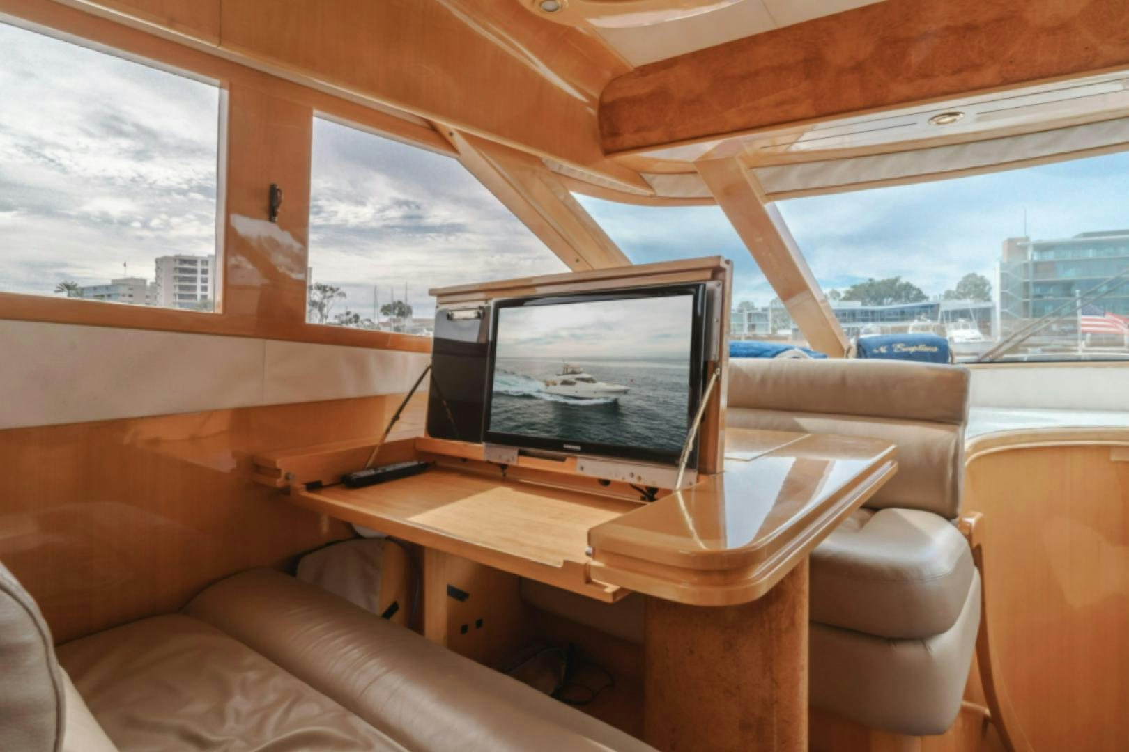 a living room with a large screen aboard no exceptions Yacht for Sale