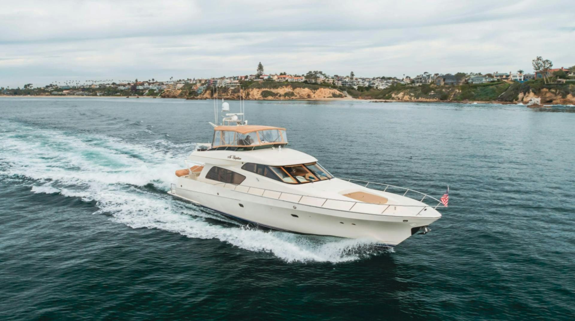 a white yacht on the water aboard no exceptions Yacht for Sale