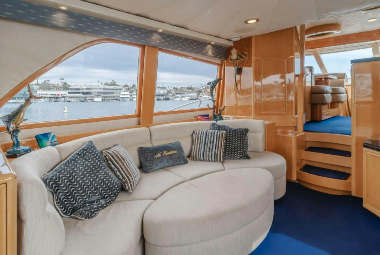 a room with a couch and a window aboard no exceptions Yacht for Sale