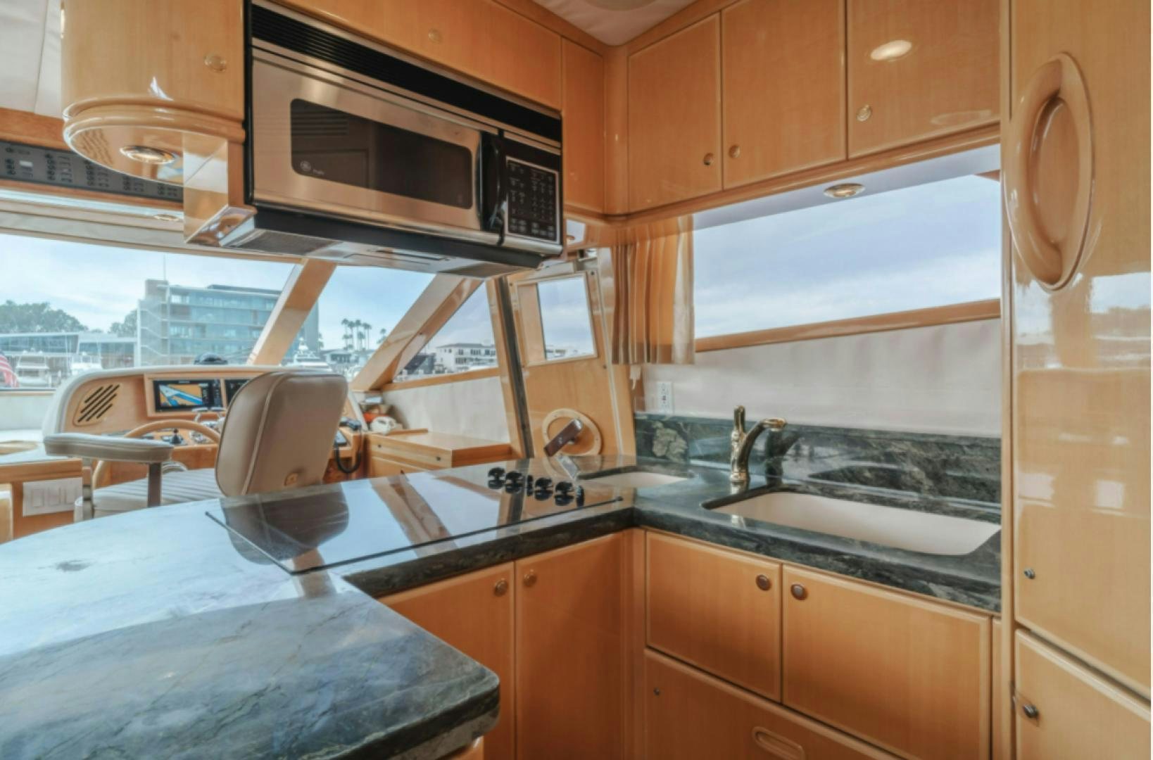 a kitchen with wooden cabinets aboard no exceptions Yacht for Sale