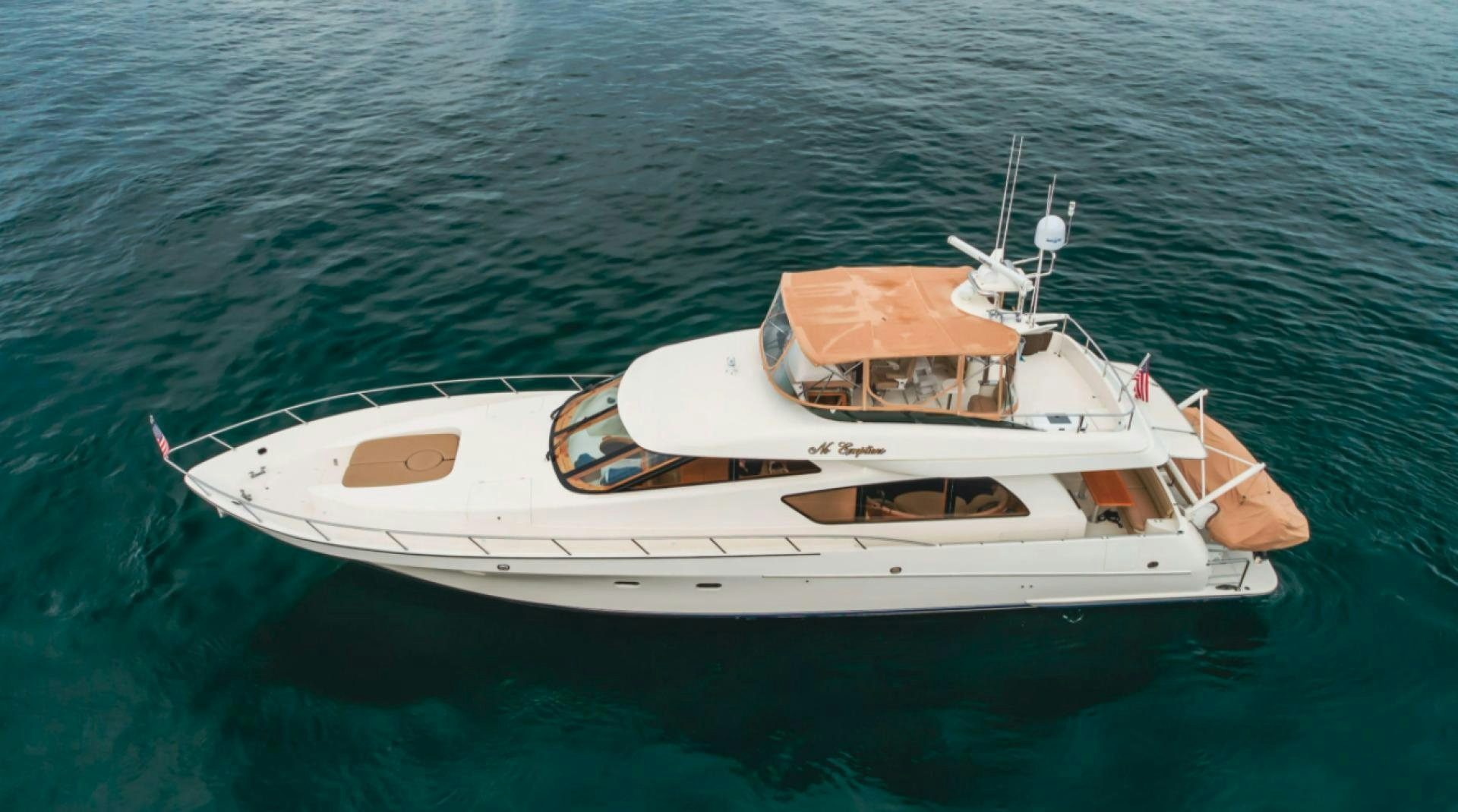 a white boat in the water aboard no exceptions Yacht for Sale