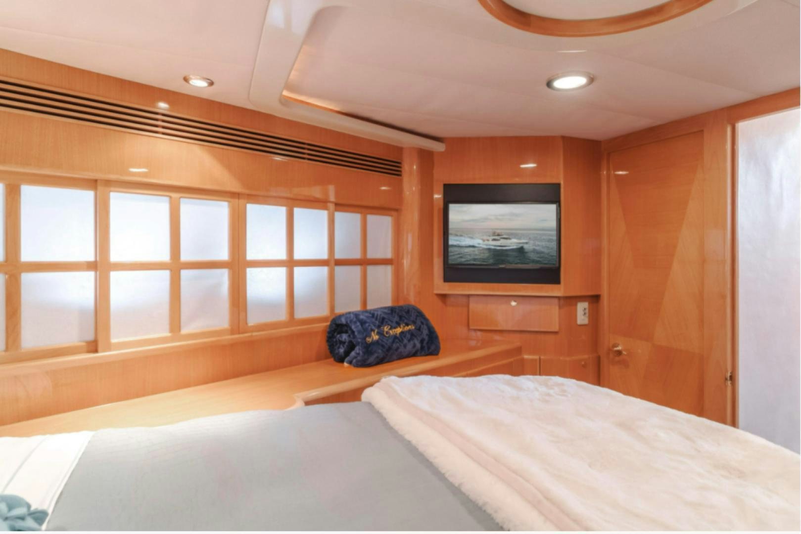 a room with a tv and a bed aboard no exceptions Yacht for Sale