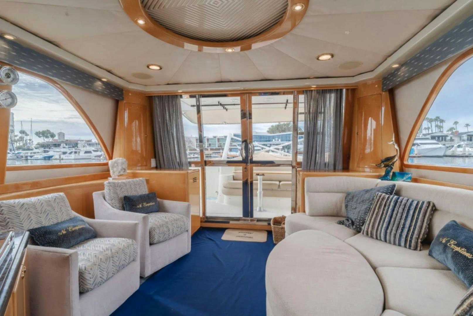 a living room with a blue rug aboard no exceptions Yacht for Sale