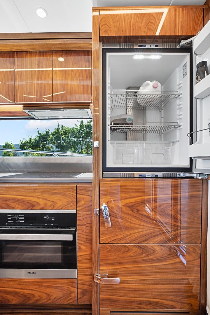 a kitchen with a refrigerator aboard YOUNG HEARTS Yacht for Sale