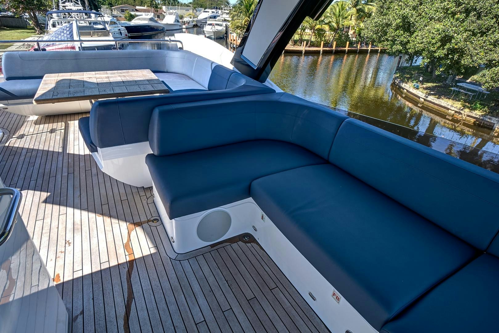 a pool with a deck and a deck and trees aboard YOUNG HEARTS Yacht for Sale
