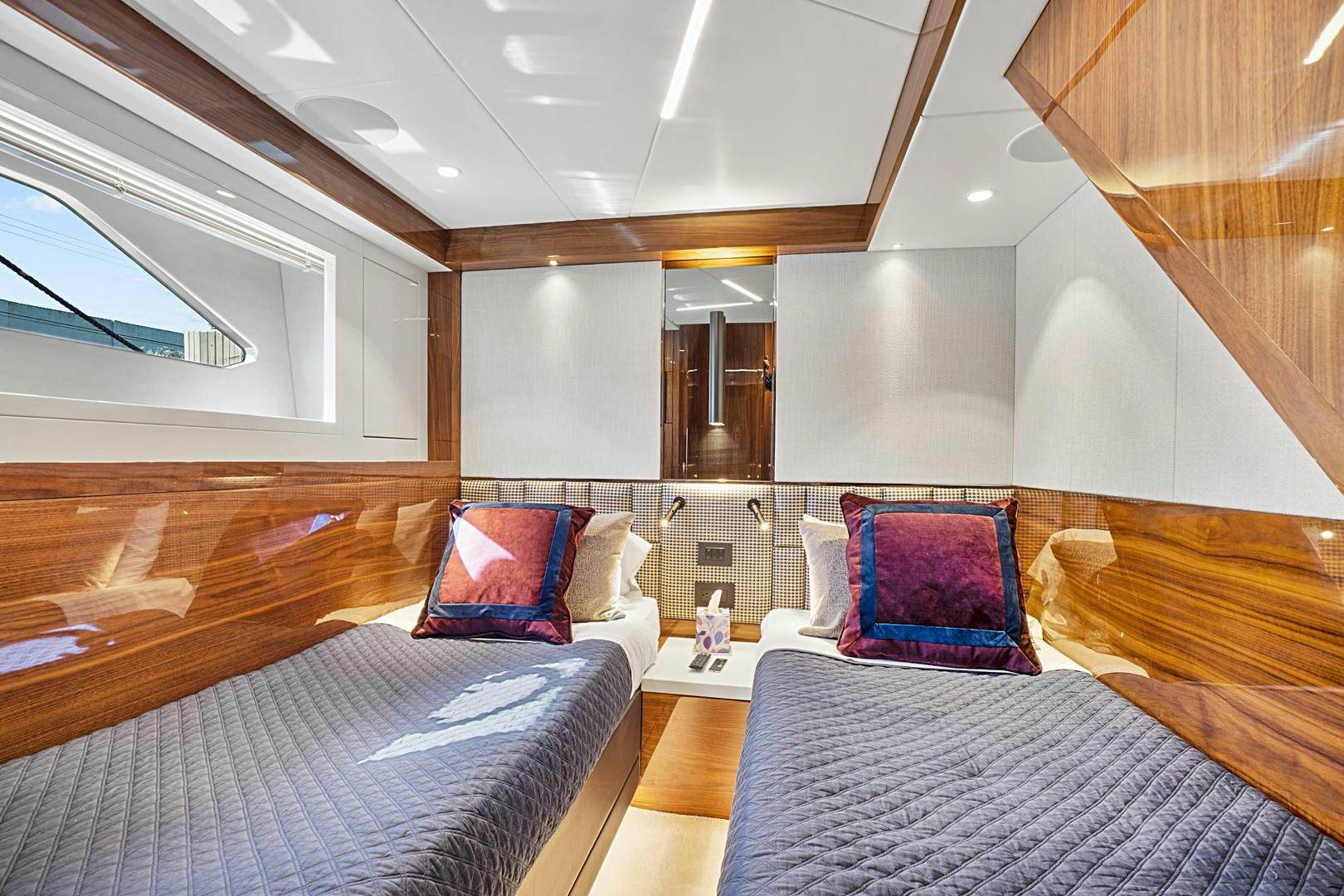 a room with a bed and a mirror aboard YOUNG HEARTS Yacht for Sale